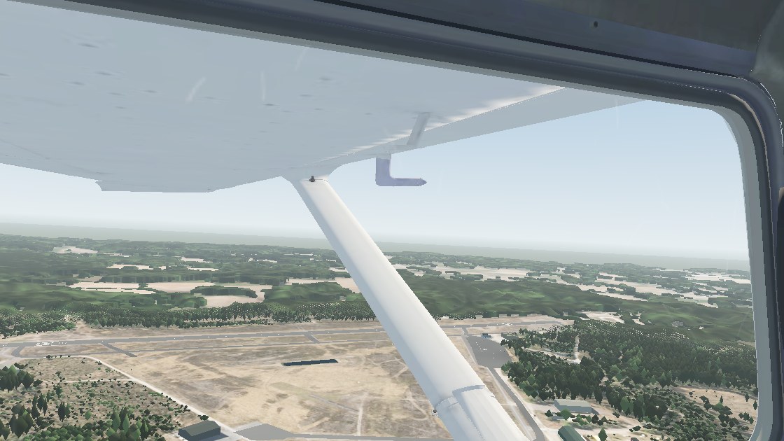 Left cockpit window view of Vesivehmaa runway from the downwind starting point
